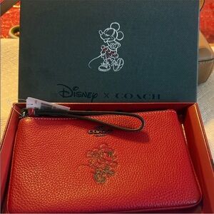 Disney Coach Minnie Mouse Motif Wristlet in red pebble leather. NWT